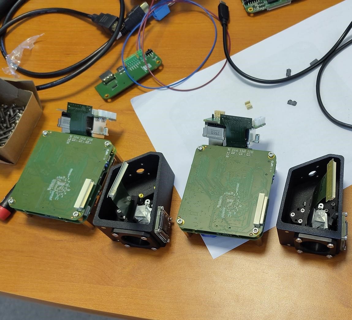 Disassembled PRO-PIX camera units showing the internal optics and circuit boards