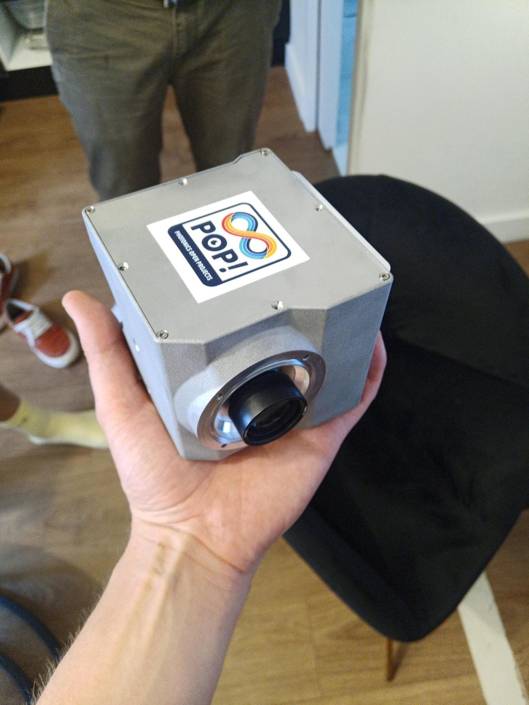 A hand holding an assembled PRO-PIX camera unit